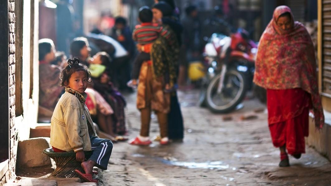 Girl sitting in a street of Nepal